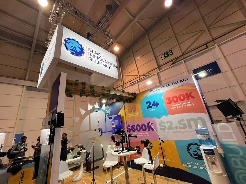 The Black Innovation Alliance booth on the conference floor at Web Summit 2022